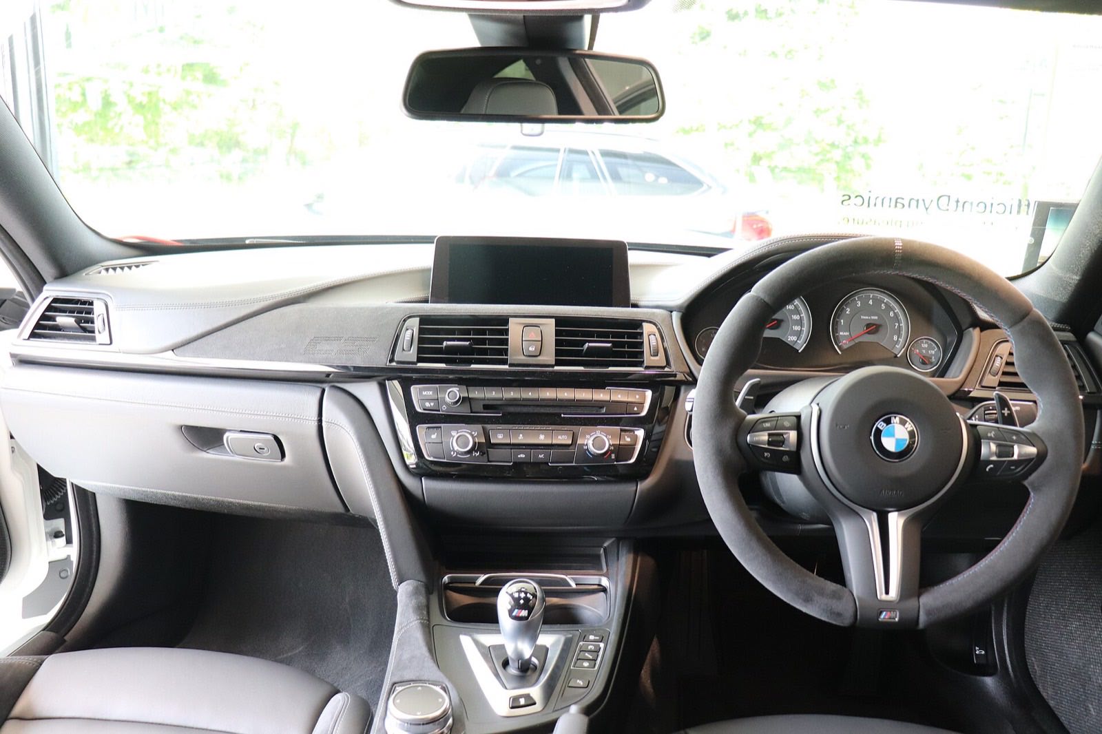 Cleaned dashboard and steering wheel of a sports saloon with dust-free vents and clear instrument glass